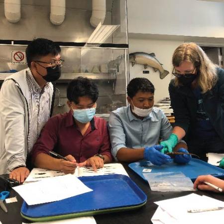 A group shot of scientists getting hands on with the fish collection.